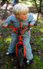 Boy on bike wearing Original Rainsuit in Manu by Ducksday